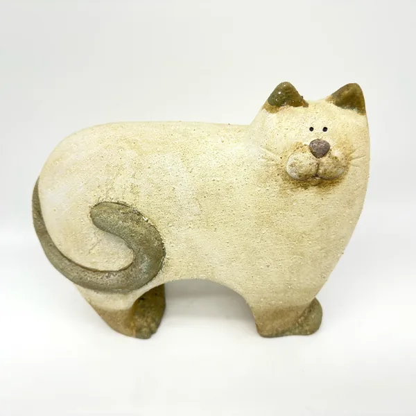 Stoneware cat from side angle showing full body, textured cream surface with distinctive swirled tail detail