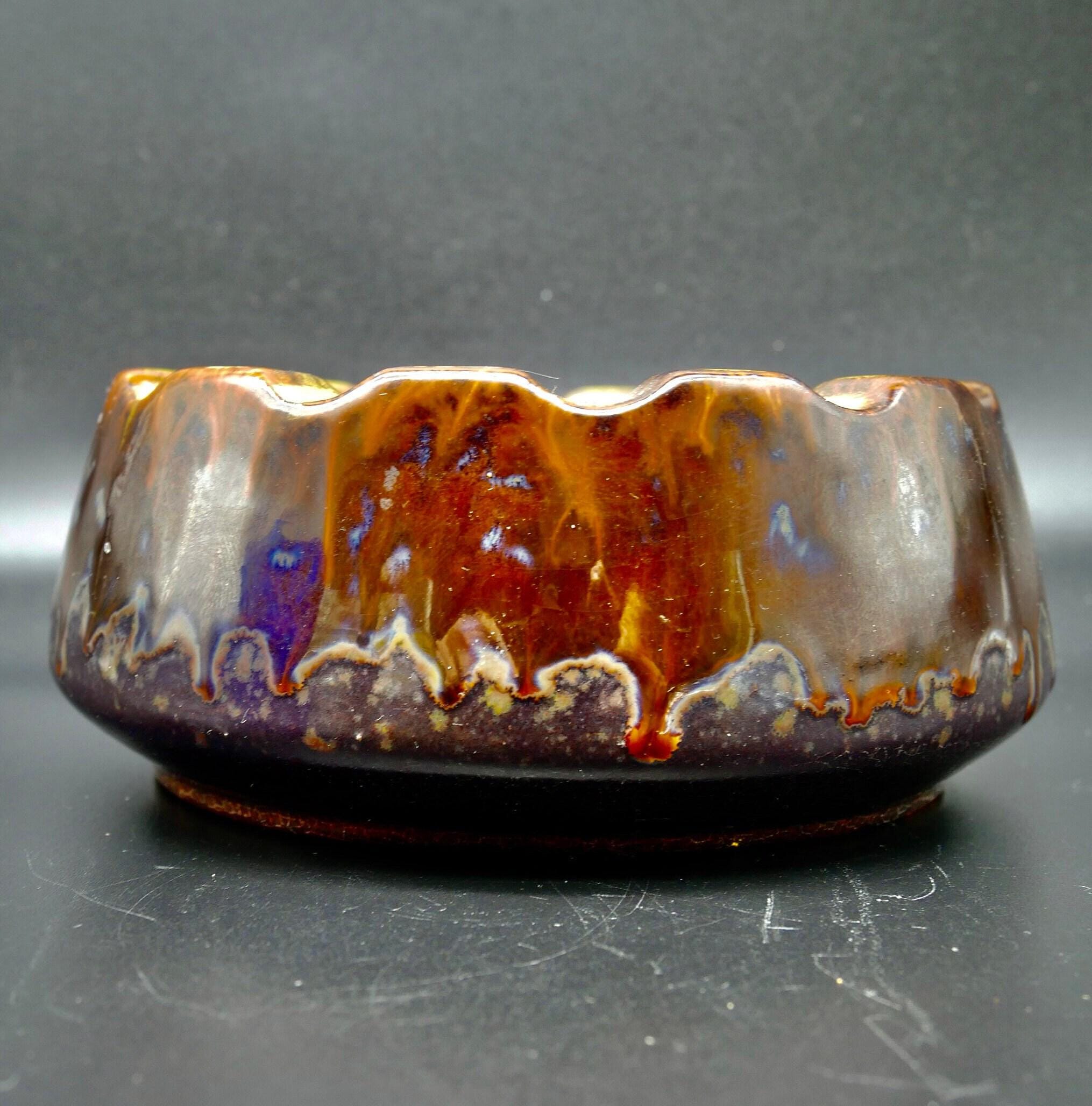 Strehla ashtray side elevation showing burgundy glaze flow, brown pooling patterns, base foot detail