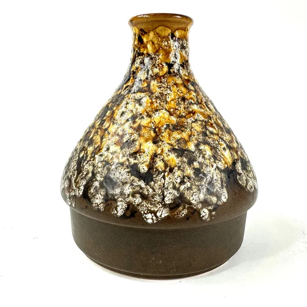 Studio light illuminates vase from left, highlighting cream glaze peaks against chocolate-brown shadows