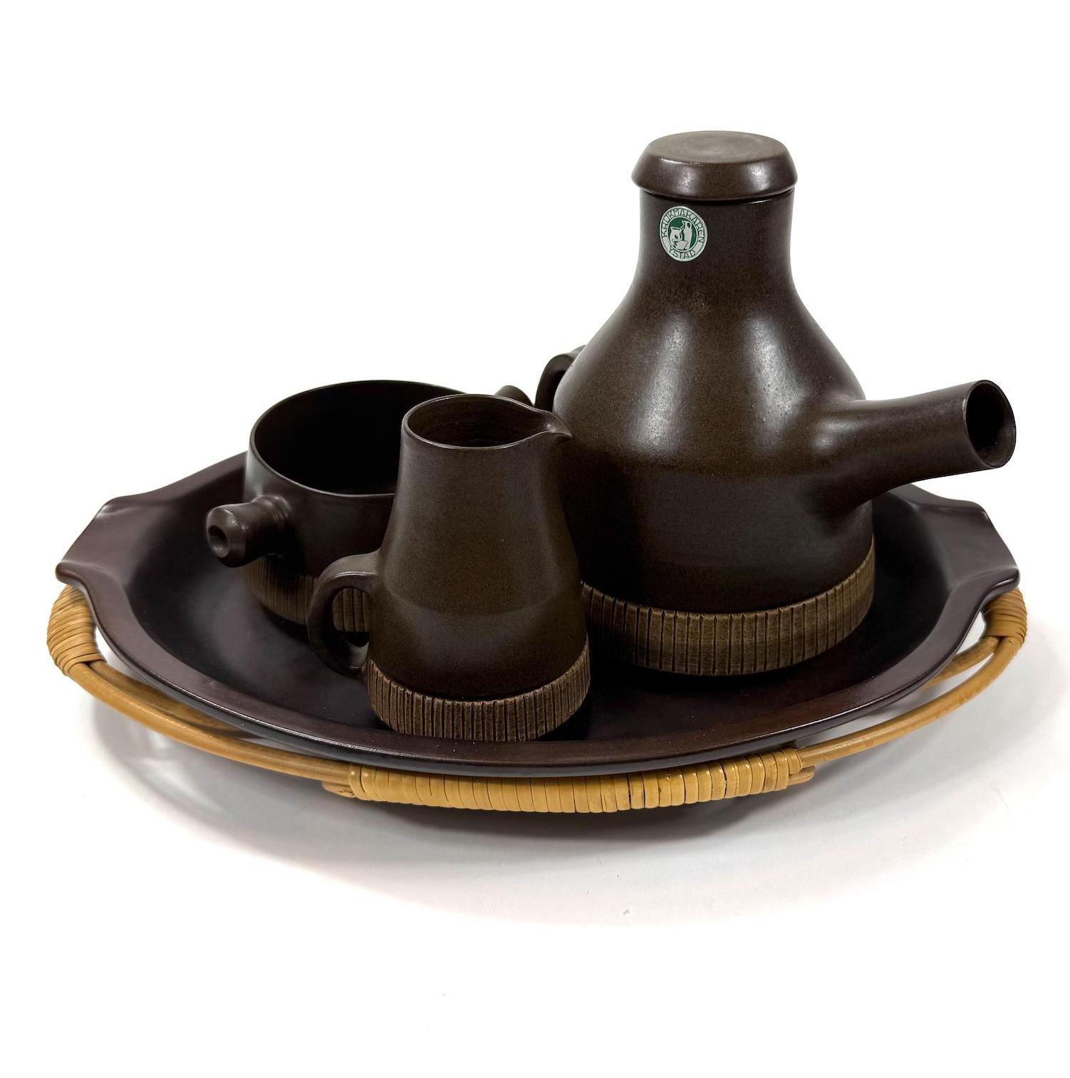 Swedish stoneware coffee set with dark brown glazed pot, creamer, sugar bowl on woven cane tray, 1970s