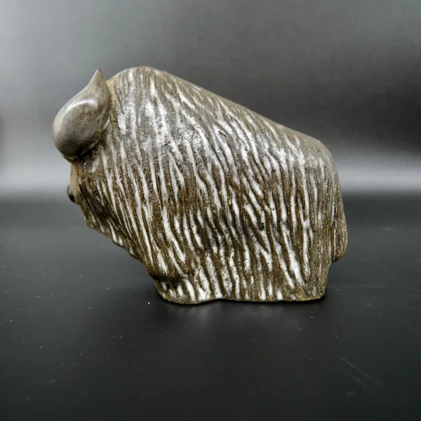Three-quarter back view of vintage bison sculpture showing curved hindquarters and complete textured surface treatment