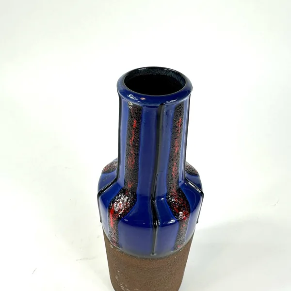 Tilted overhead angle showing vase opening, visible interior, glazed exterior surface texturing, and shoulder-to-neck proport