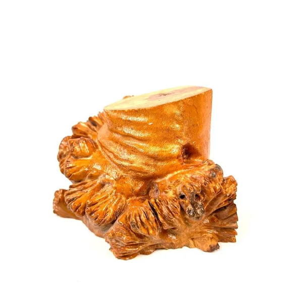 Tilted perspective of carved burl wood bookend emphasizing sculptural form, root fiber texture, and three-dimensional depth