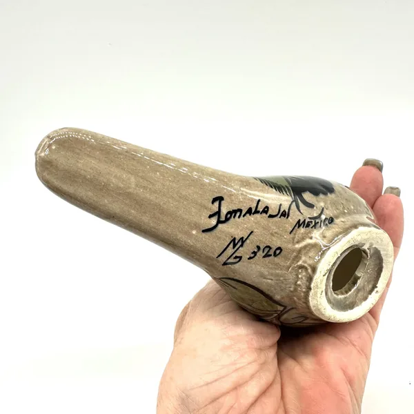 Tonalá pottery maker's signature and date mark on bird sculpture base, showing artist handwriting and size marking