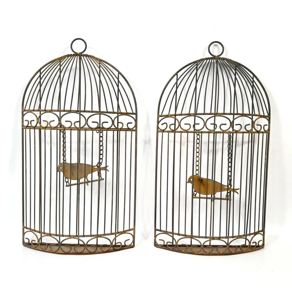 Two birdcages side-by-side comparison showing matching pair detail, identical scrollwork, and paired display arrangement