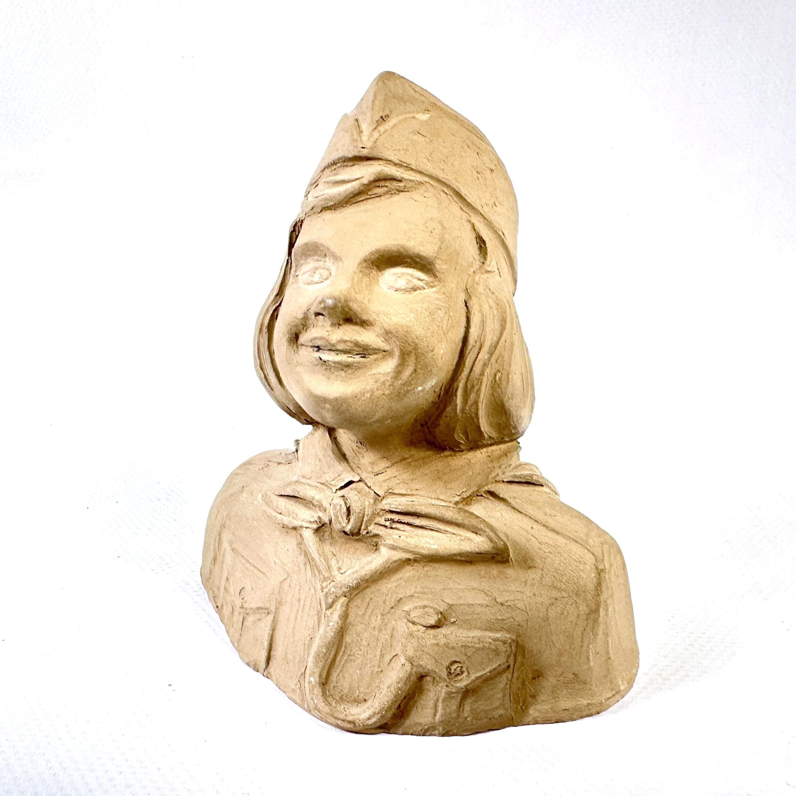 Vintage 1949 plaster bust of smiling Girl Guide with cap, neckerchief, and warm expression, signed NBS