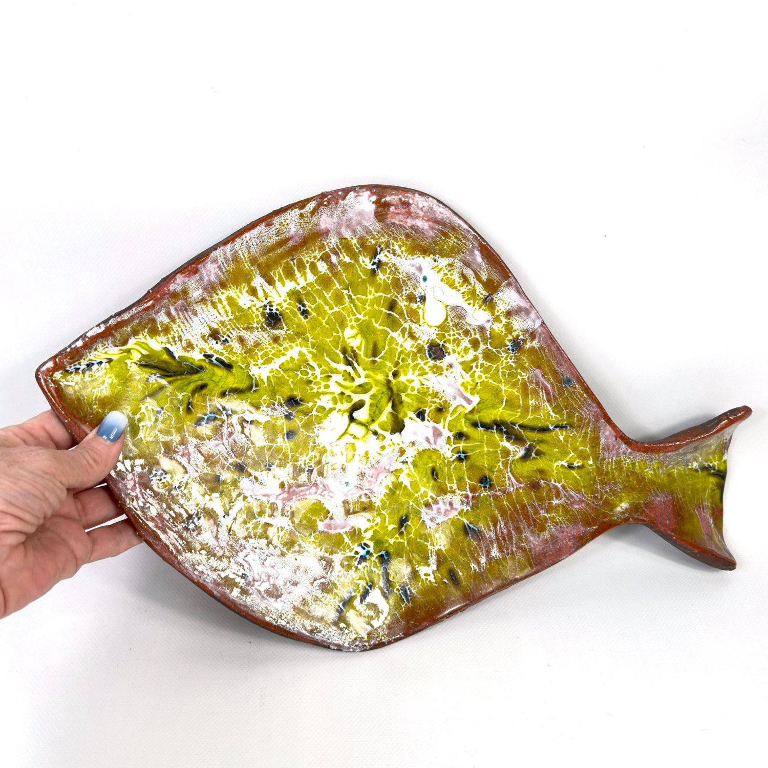 Vintage 1960s studio pottery fish platter with yellow-green crackle glaze, white and pink accents, held in hand to show scale