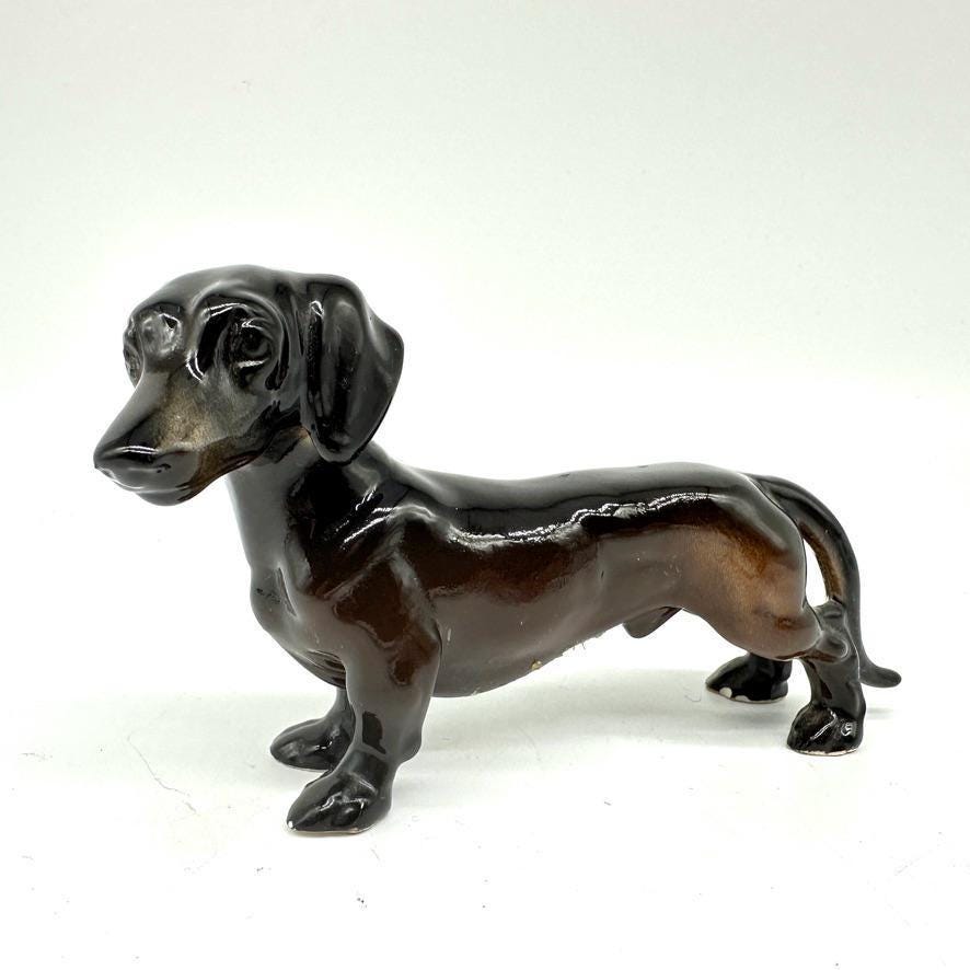 Vintage brown glazed ceramic dachshund figurine, mid-century standing pose with glossy finish and expressive face, three-quar