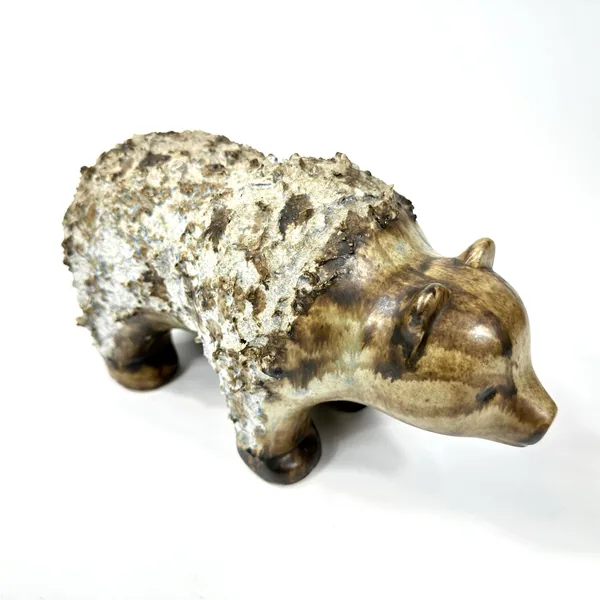Vintage ceramic bear with visible glazing detail showing contrast between textured cream patina and darker bronze stoneware