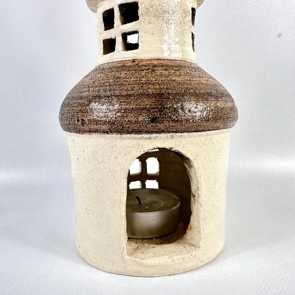 Vintage ceramic candle house interior cavity view, empty chamber ready for tealight, rounded interior passage, worn stoneware