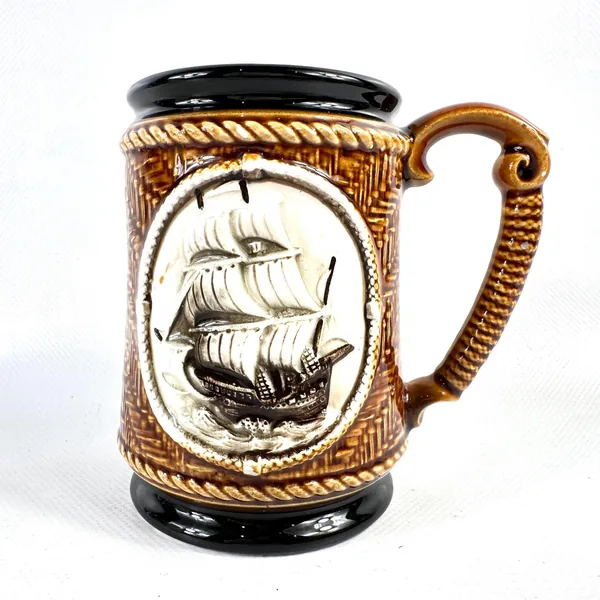 Vintage ceramic tankard front-facing with tall ship sailing vessel and nautical rope border frame detail