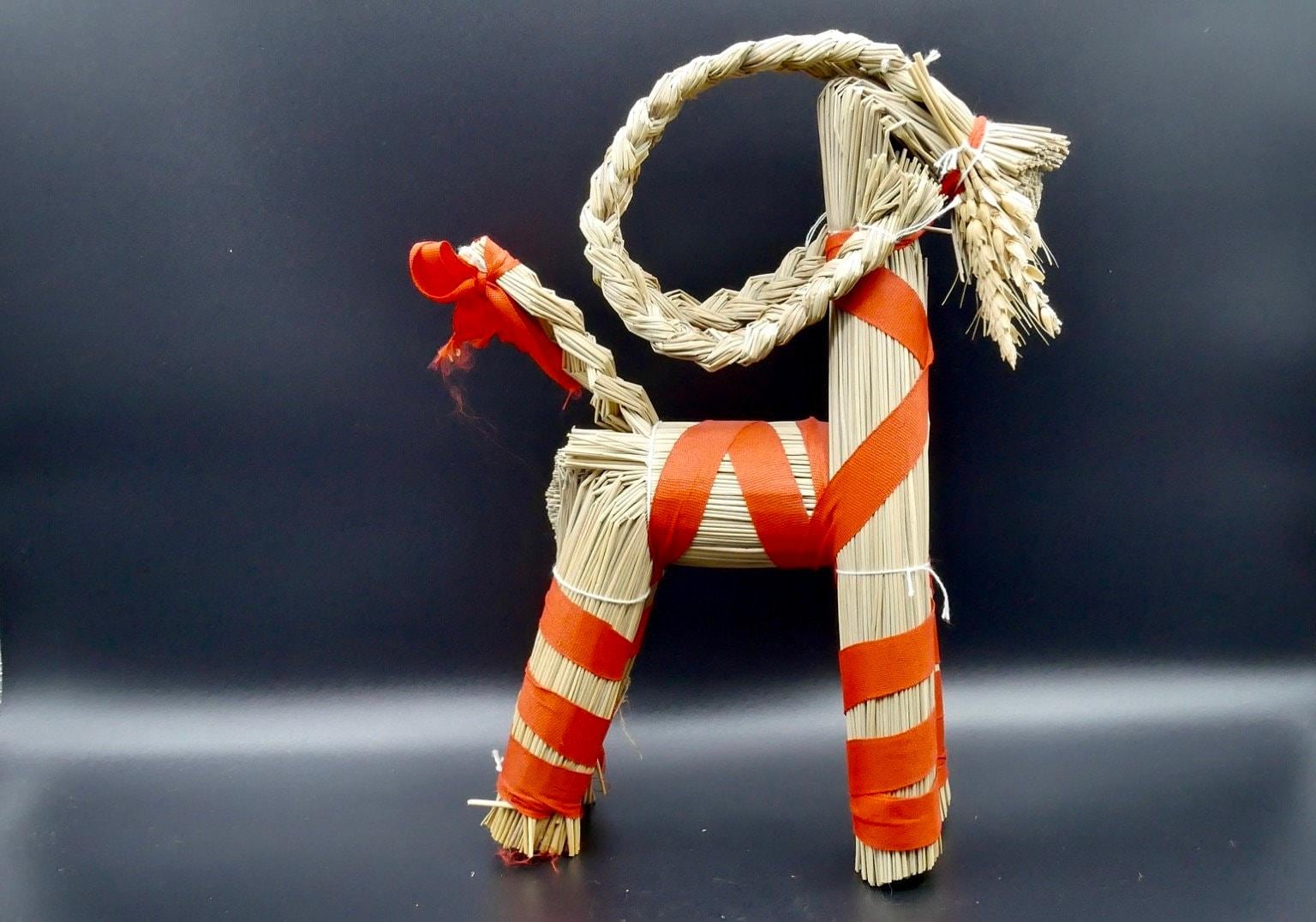 Vintage Scandinavian straw Christmas goat with natural rope neck, red-orange striped woven fabric body, and cream-colored leg