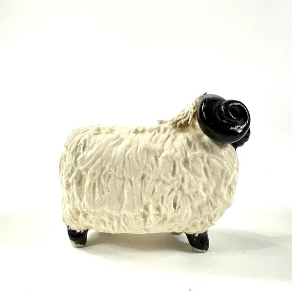 Vintage Scottish ceramic ram, cream fleece texture with black face and legs, direct side elevation view