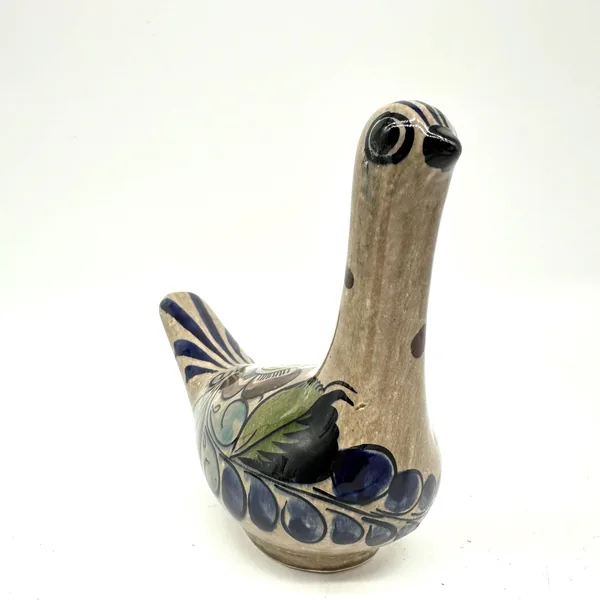 Vintage Tonalá ceramic bird tall angle view, displaying elongated neck and positioned decorative wing with navy stripes