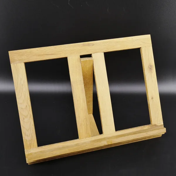 Wooden recipe stand three-quarter view, flat lay position, frame structure visible, natural wood patina and aging details sho