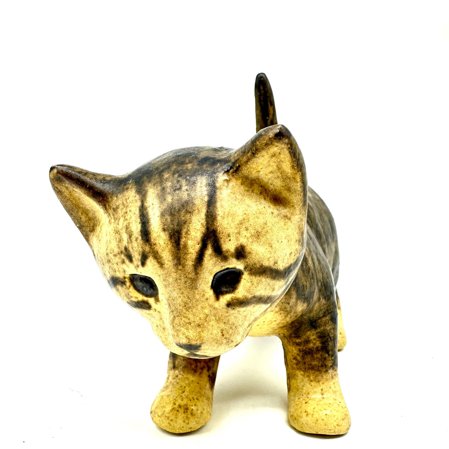 Ceramic cat face close-up showing alert expression, ear detail, and golden glaze on muzzle and paws