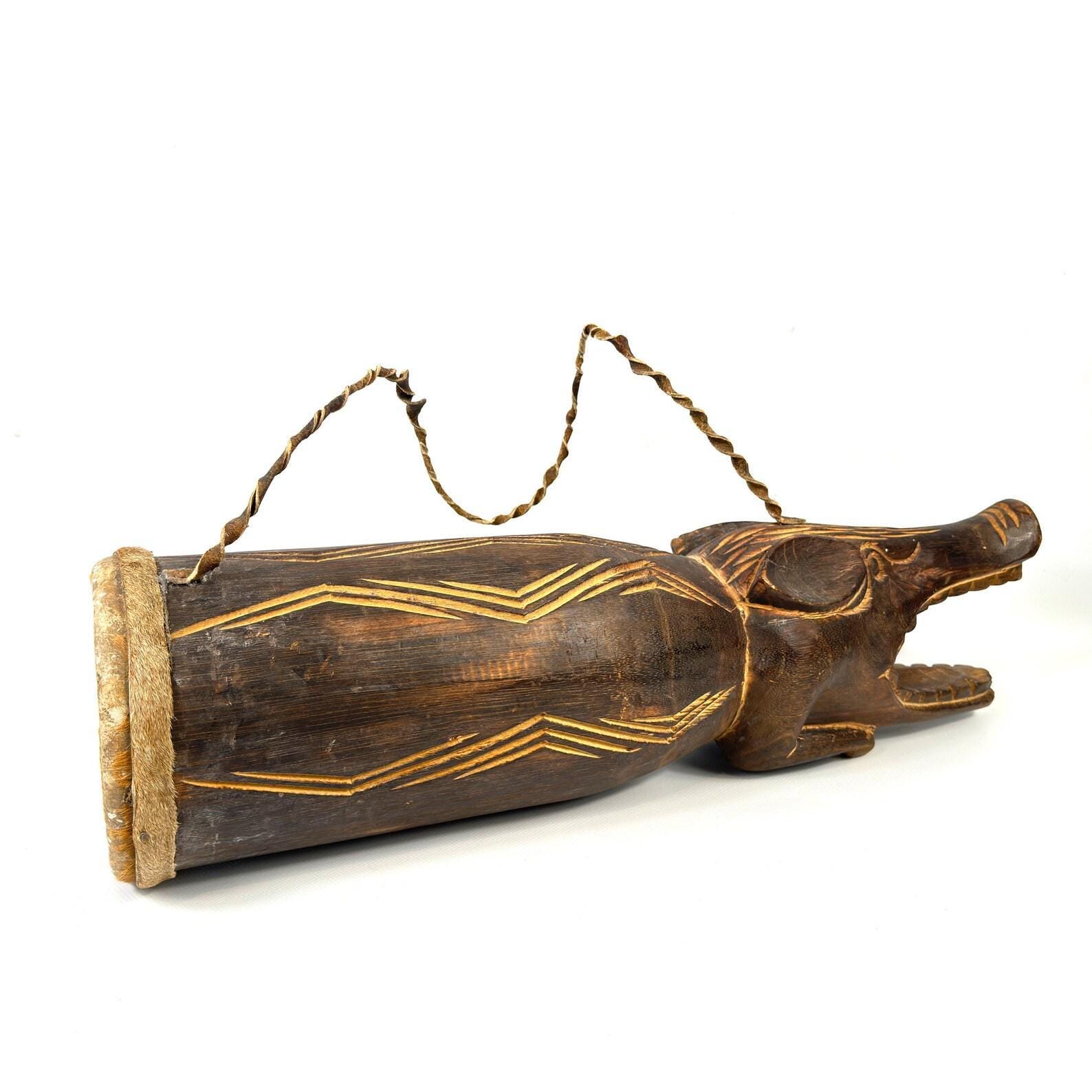 Drum end cap showing natural wood grain, weathered patina, and structural joint where head connects to barrel