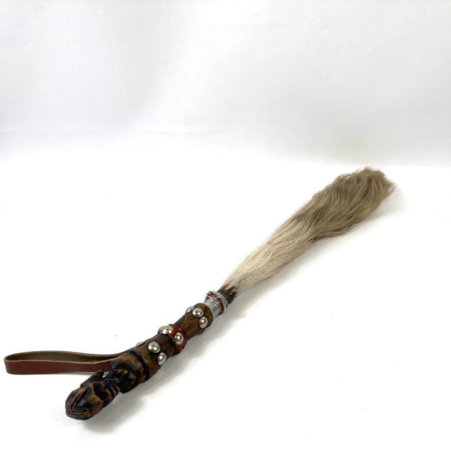 Final angled view showing handle metalwork detail, carved top, leather bands, and horsehair bristle texture and volume