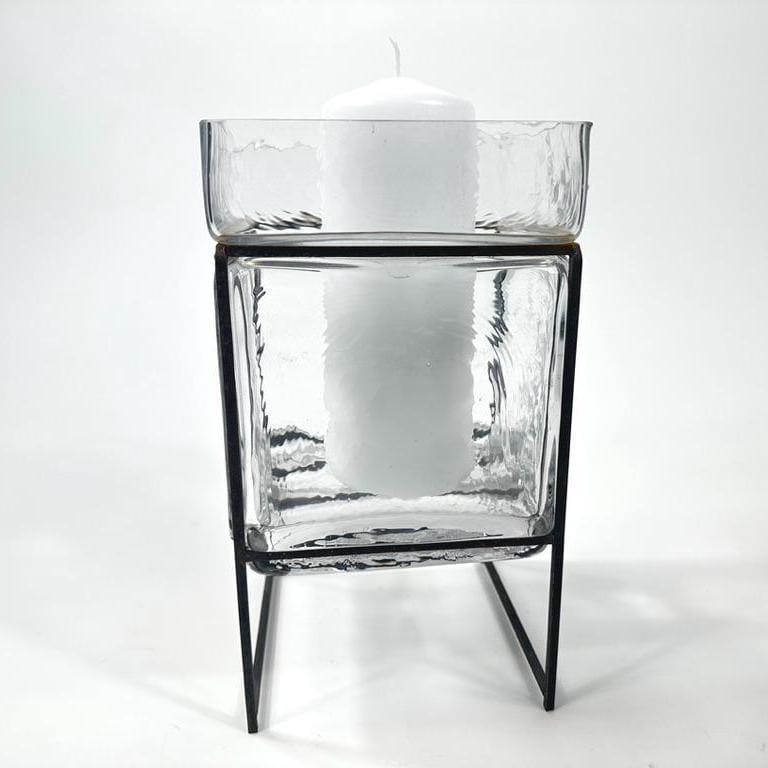 Front-facing view of glass candleholder revealing vertical textured pattern and wrought iron base with candle holder top