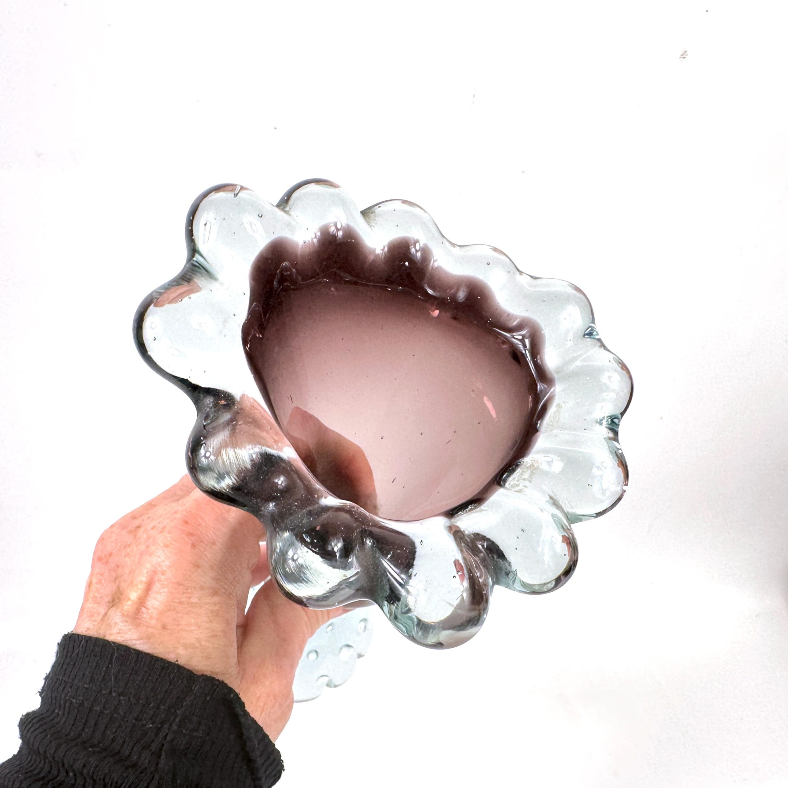 Hand holding Åseda vase showing scale and interior cavity depth