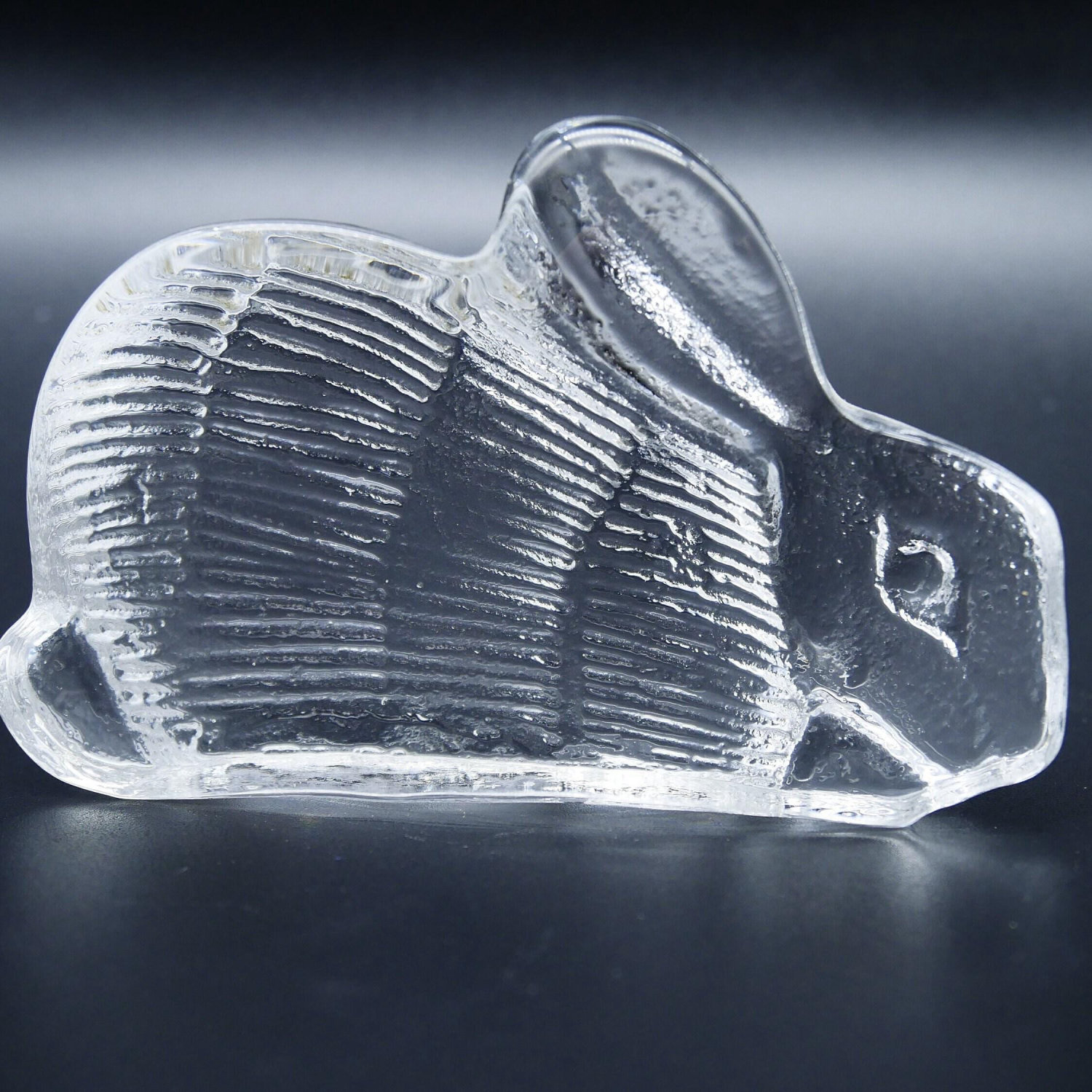 Lisa Larson clear glass rabbit figurine, Swedish Royal Krona 1970s, side profile view showing ribbed body texture