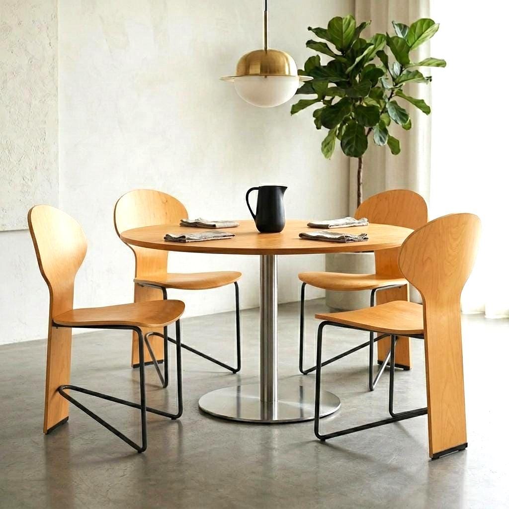 Pair of Lammhults Mosquito chairs with sculpted bentwood backs and steel frames in a modern dining setting with round table