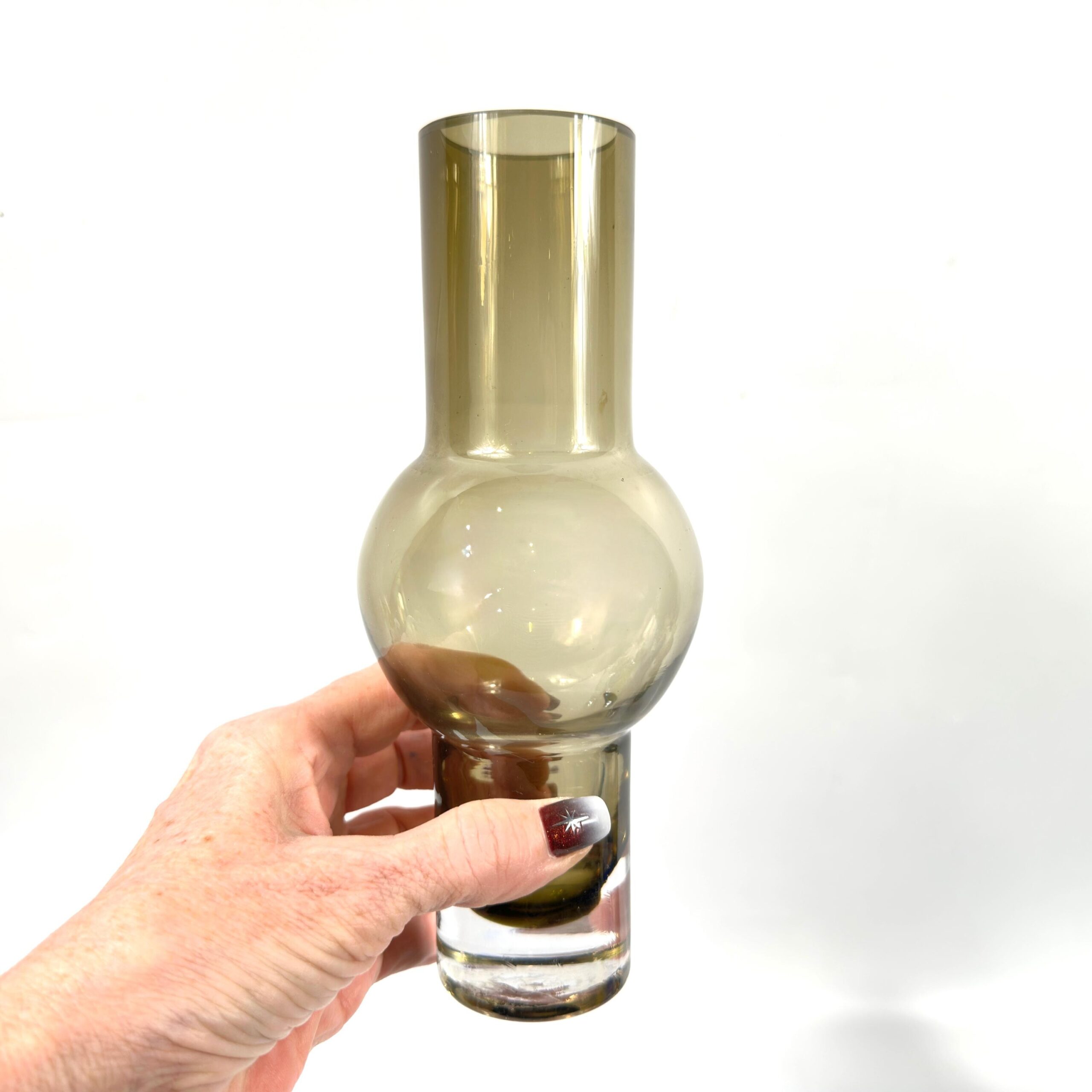 Riihimäen Lasi vase held in hand, 1960s bubble glass, warm smoky brown Finnish design showing scale and sculptural presence