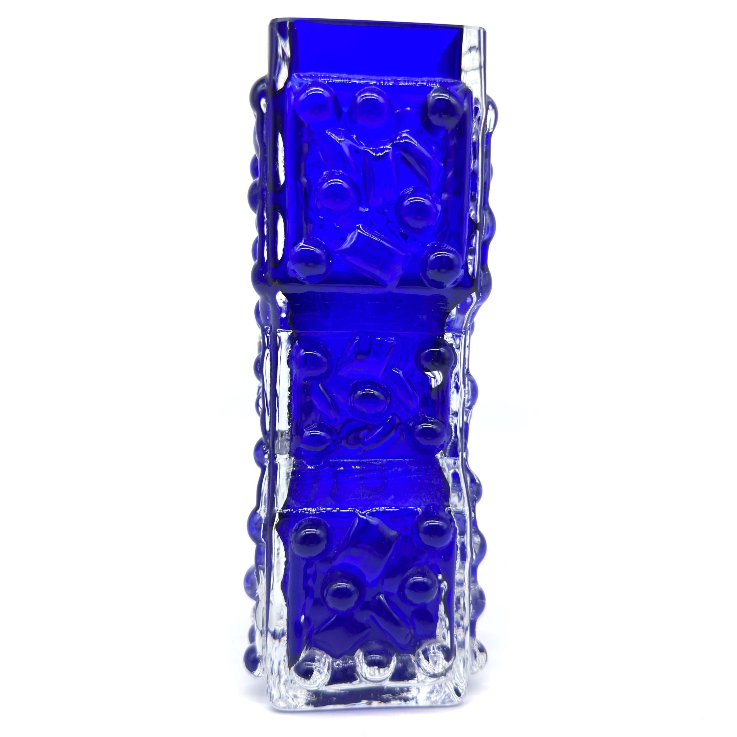 Textured cobalt vase narrow waist silhouette, bubble pattern visible along full height, side profile view emphasizing hourgla
