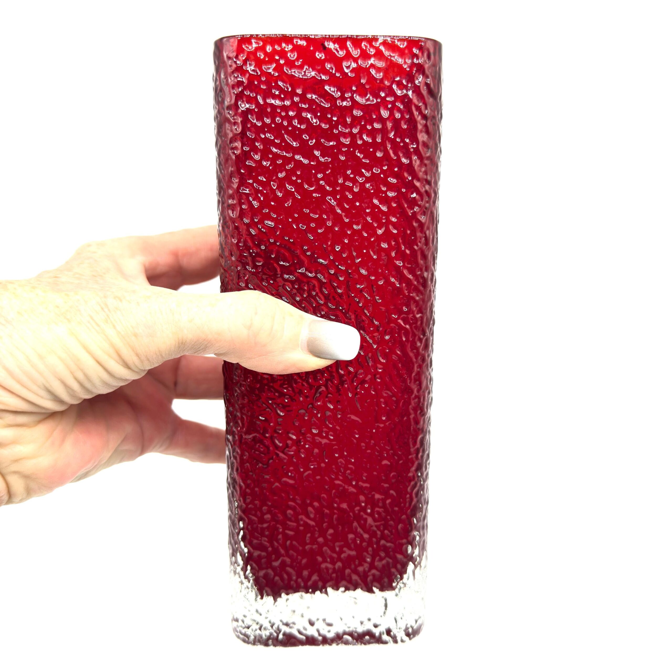 Vintage Scandinavian red textured glass vase held in hand, square form with ruby tone fading to clear base