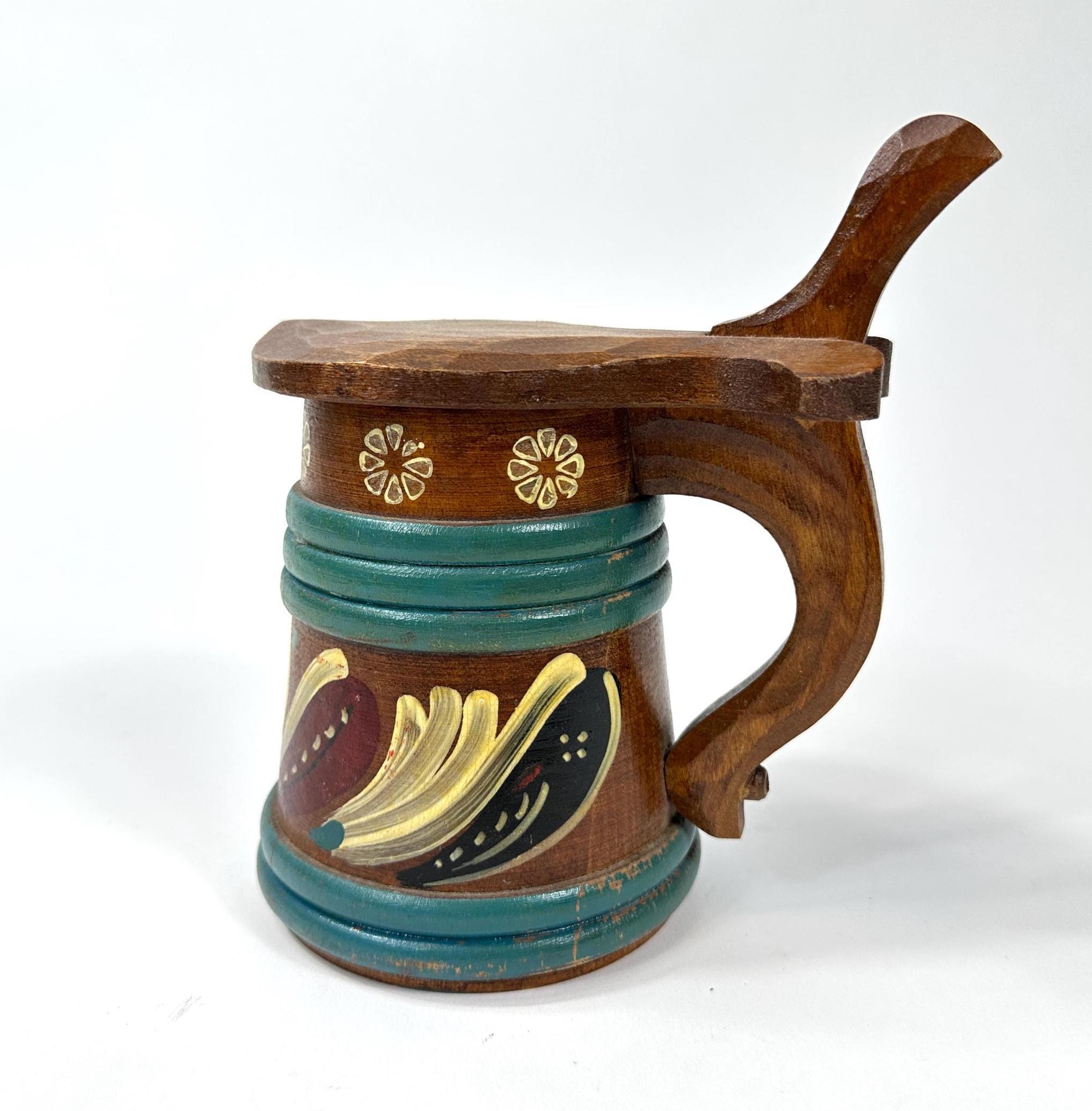 Scandinavian wooden ale tankard with turquoise hand-painted bands, carved hinged lid, and folk art floral motif, front view