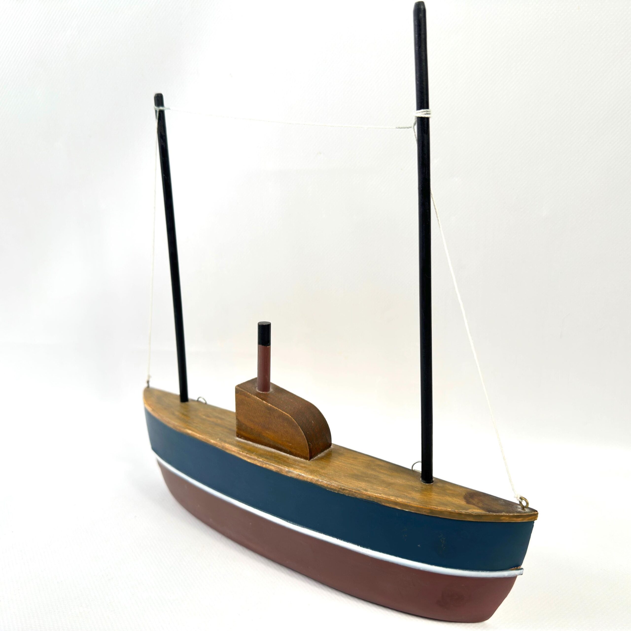 Wooden half-hull model from side profile, showing hull curve, navy stripe, burgundy base, single cabin detail