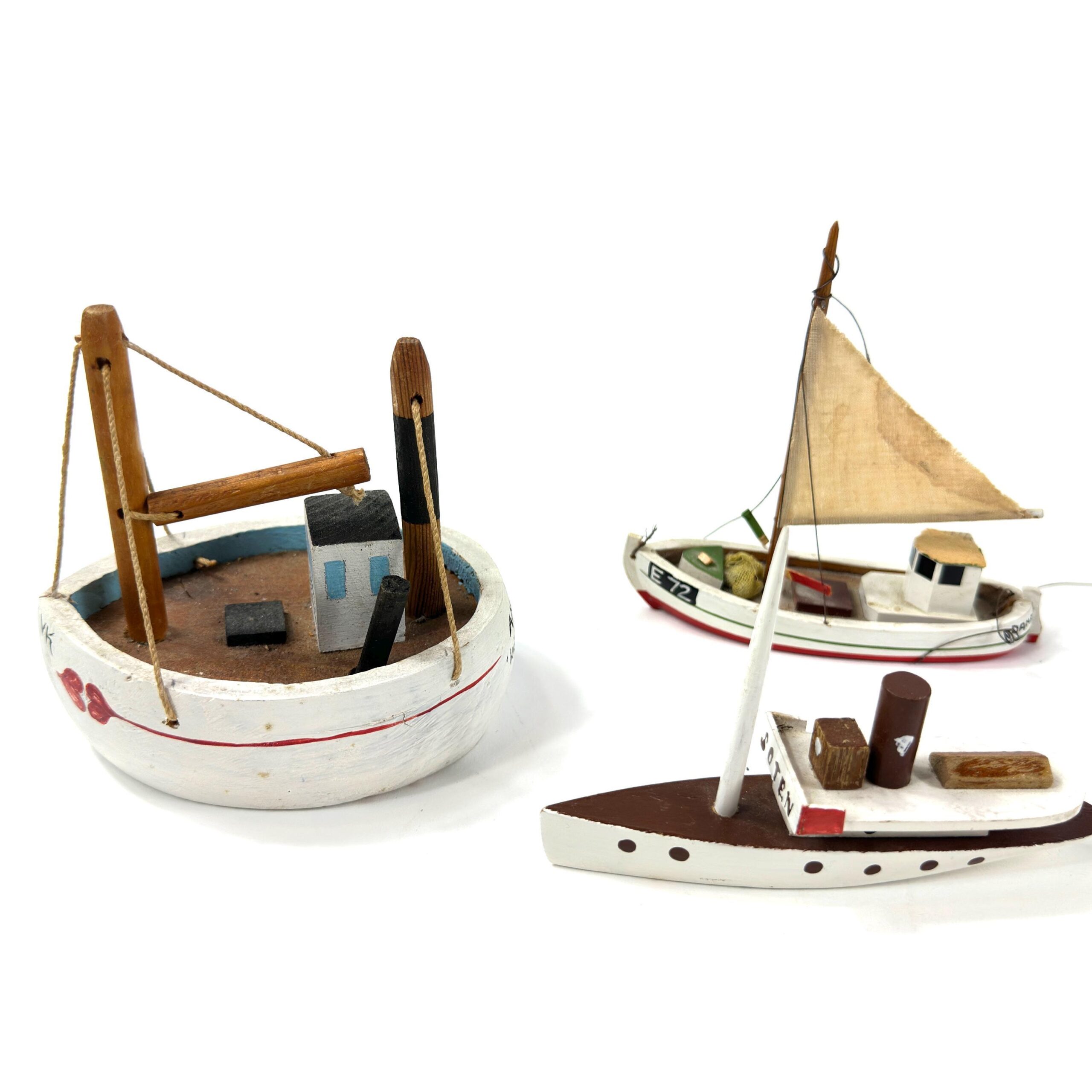 Wooden sailboat collection with focus on white hulls, hand-painted cabin decoration, and traditional rigging construction