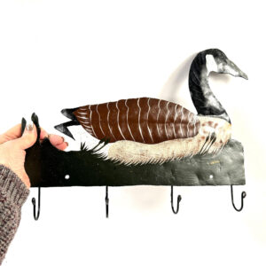 Hand-painted Canada goose wall rack with four metal hooks, featuring brown plumage, black head, cream markings, and green ree