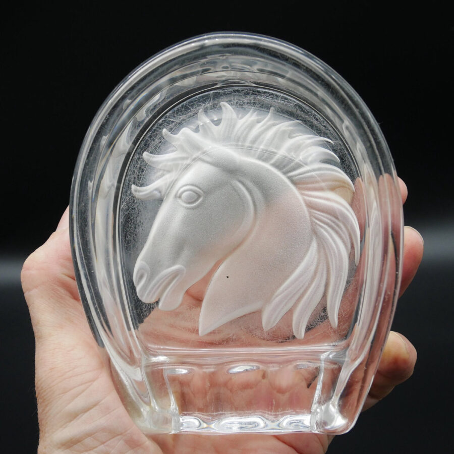 French Sevres crystal craftsmanship in your hands. A timeless piece for the discerning collector. Sevres crystal cigar ashtray with frosted etched horse head, horseshoe shape, held in hand against dark background