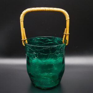 Vintage green crackle glass ice bucket with woven bamboo handle, front three-quarter view showcasing textured surface