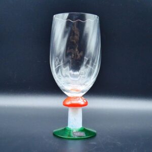 Mid-century crystal champagne flute with mushroom stem, red and white accent, green base, front view