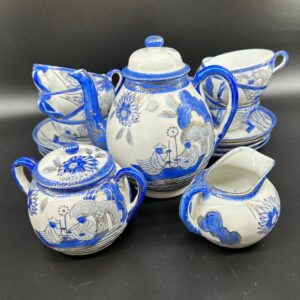 Blue and white Japanese eggshell porcelain tea set with fishing village pattern, includes teapot, sugar bowl, creamer, and cu