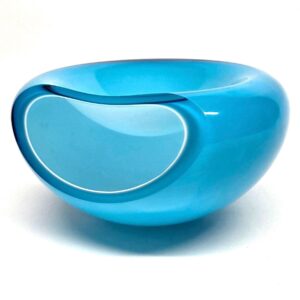 Eva Solo The Smile blue glass bowl, 1990s Danish design, three-quarter view showing curved handle cutout and glossy finish