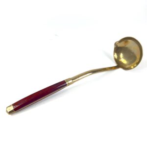 Scandinavian mid-century brass sauce ladle with octagonal rosewood handle, full profile view showing curved bowl and offset n
