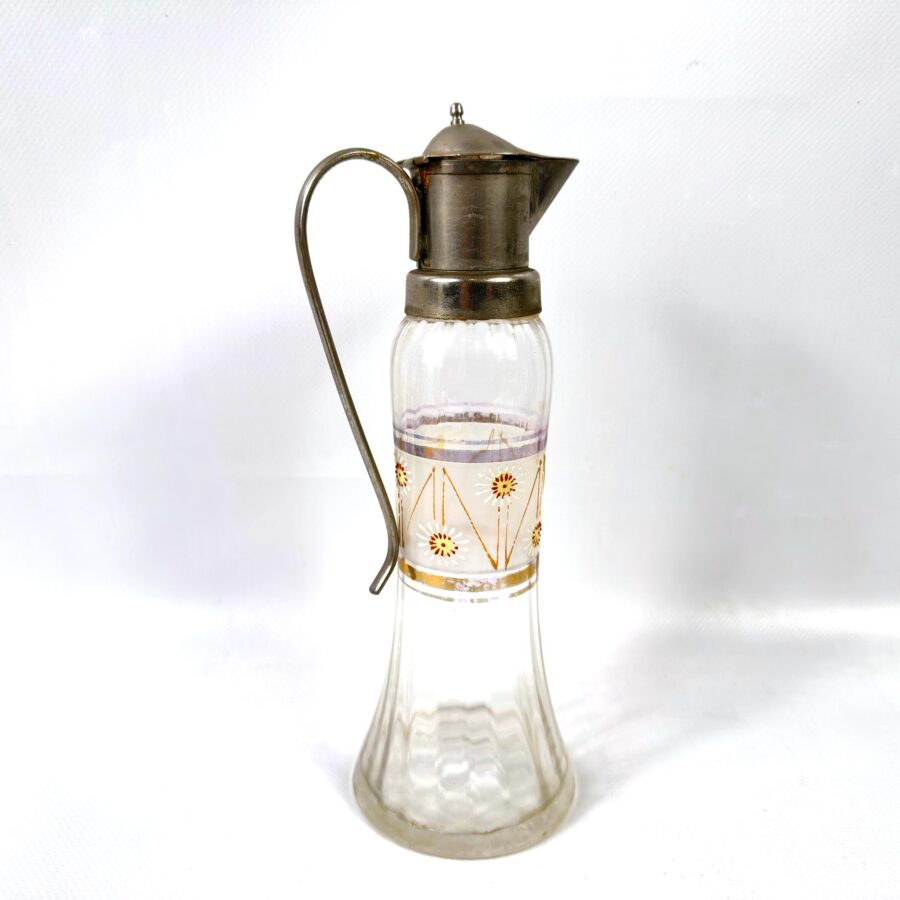 Vintage European glass pitcher with antique brass lid, hand-painted floral band in red and gold, curved metal handle, full fr