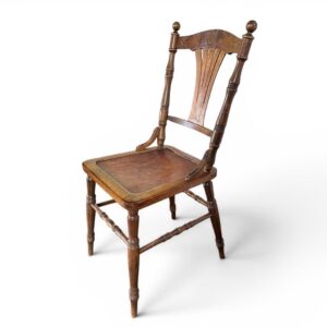 Victorian wooden side chair with turned legs, spindle back, and aged honey-brown finish, full frontal view