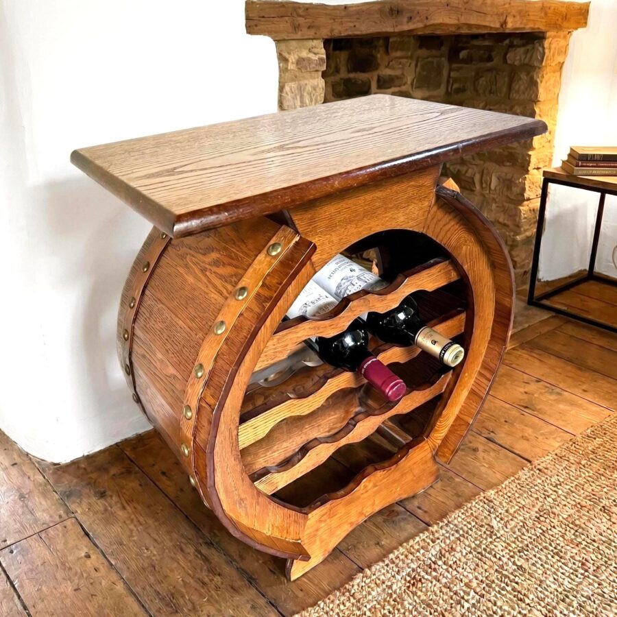 Scandinavian barrel wine rack with curved wooden slats, flat wooden top surface, holding multiple bottles in rustic walnut fi