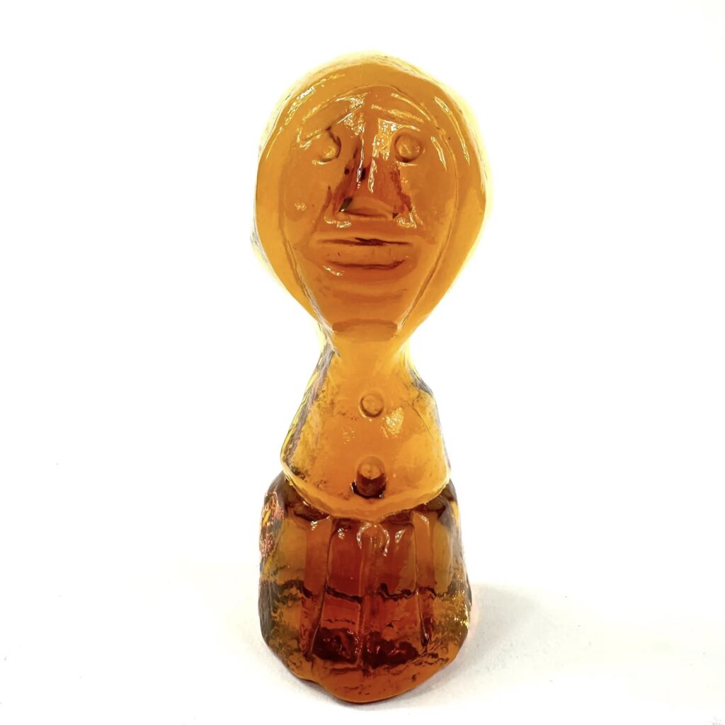 Amber glass figurative sculpture with abstract facial features and rounded lower torso, characteristic of Erik Höglund's work