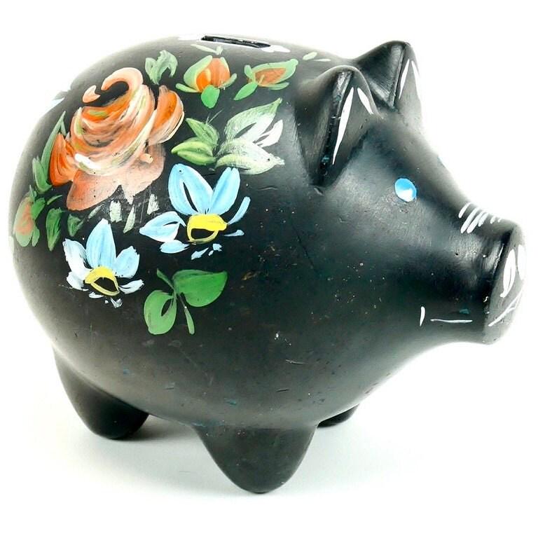 Black ceramic Norwegian piggy bank with hand-painted rosemaling florals featuring orange roses and white daisies, front-facin