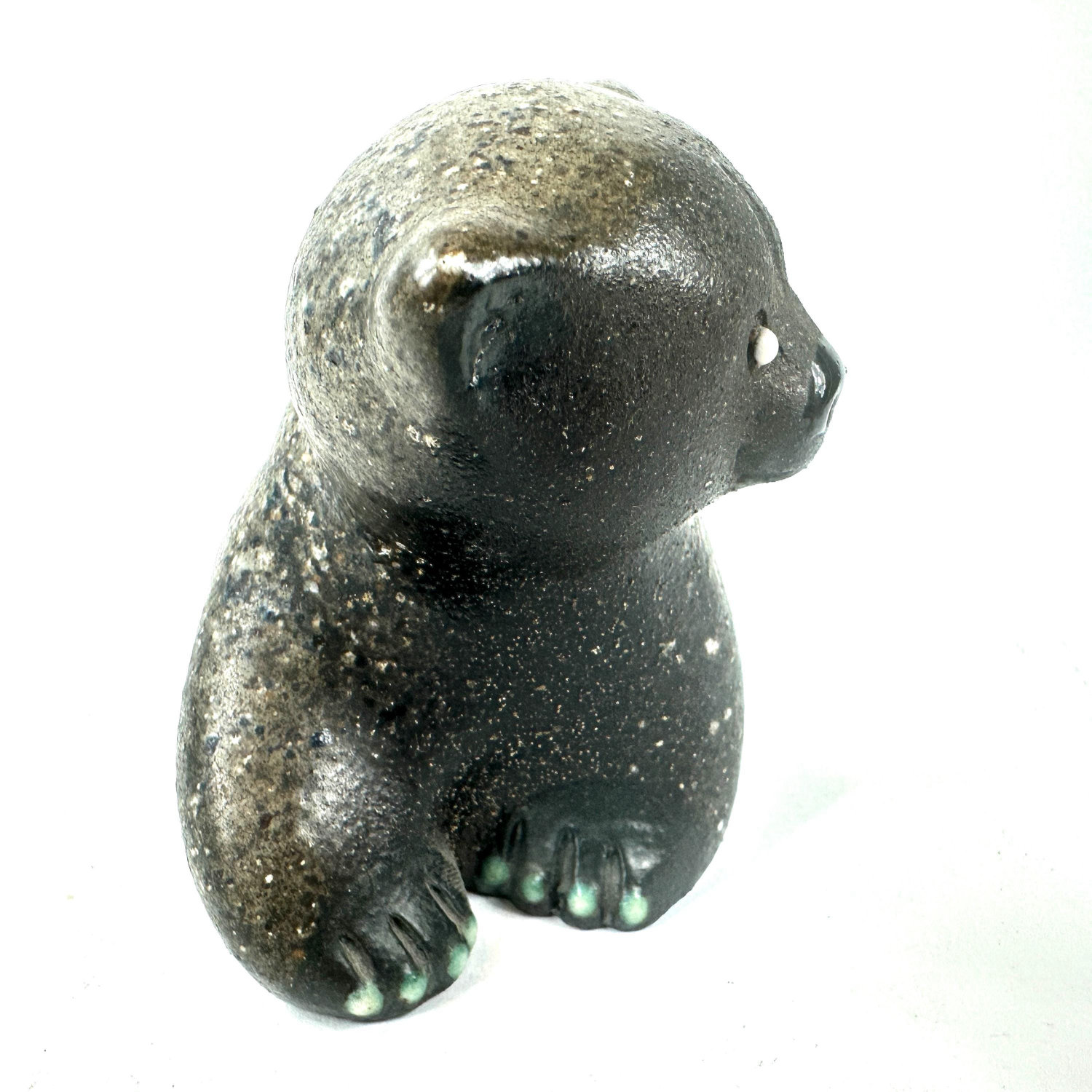 Ceramic bear viewed from behind and below, displaying back contours, tail, detailed green-glazed paw work, and textured surfa