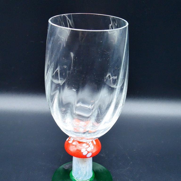 Clean front view of crystal flute with undamaged bowl, vibrant mushroom stem colors, and solid green base