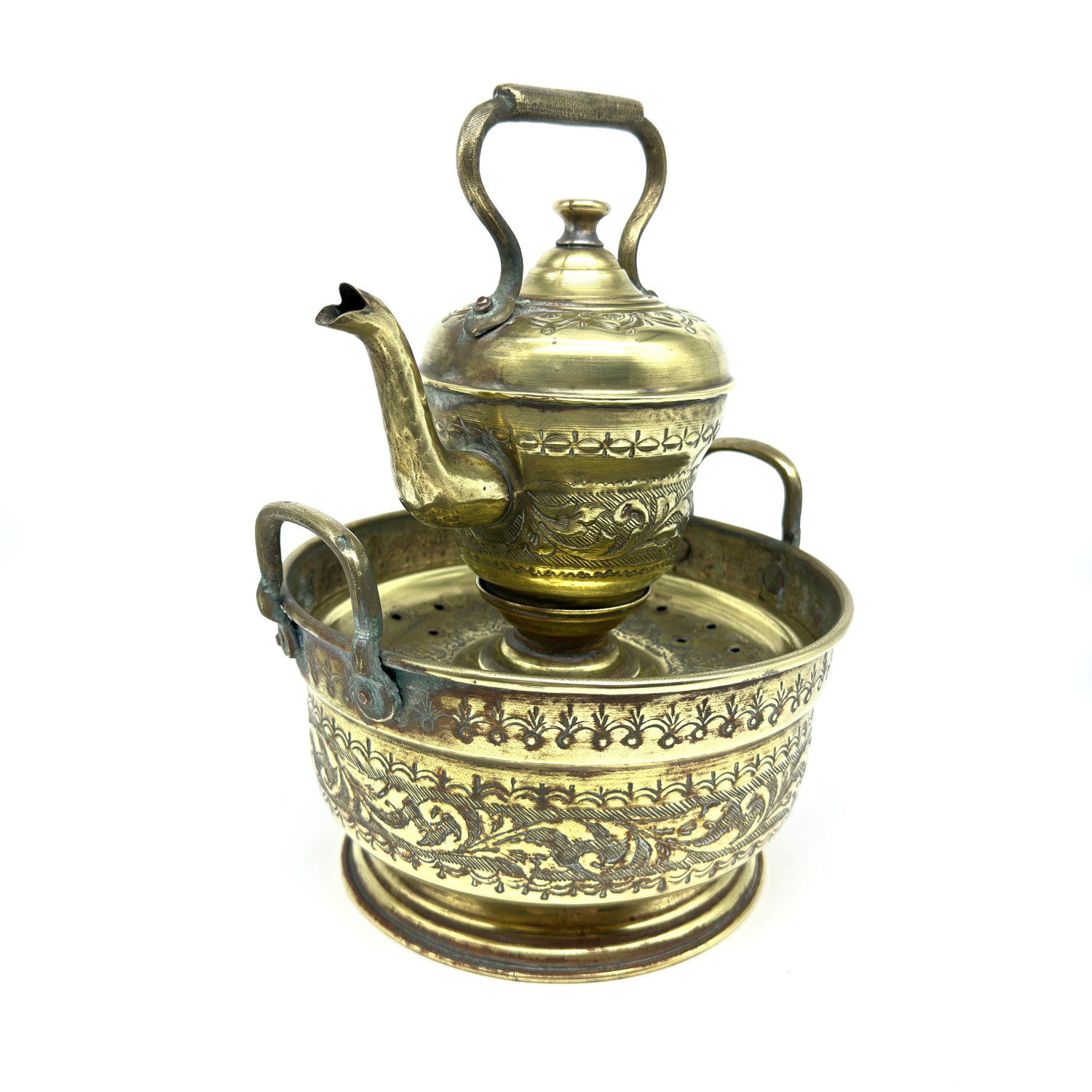 Complete set in profile showing stacked arrangement, all handles and spout visible, patina surface, and overall proportions