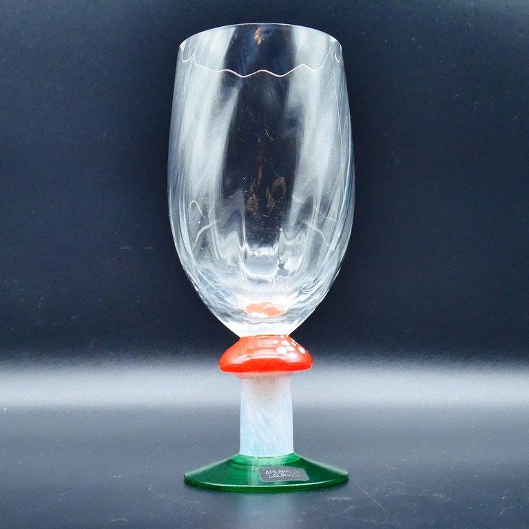 Crystal flute front view emphasizing bowl clarity and mushroom stem color blocking in red, white, and green