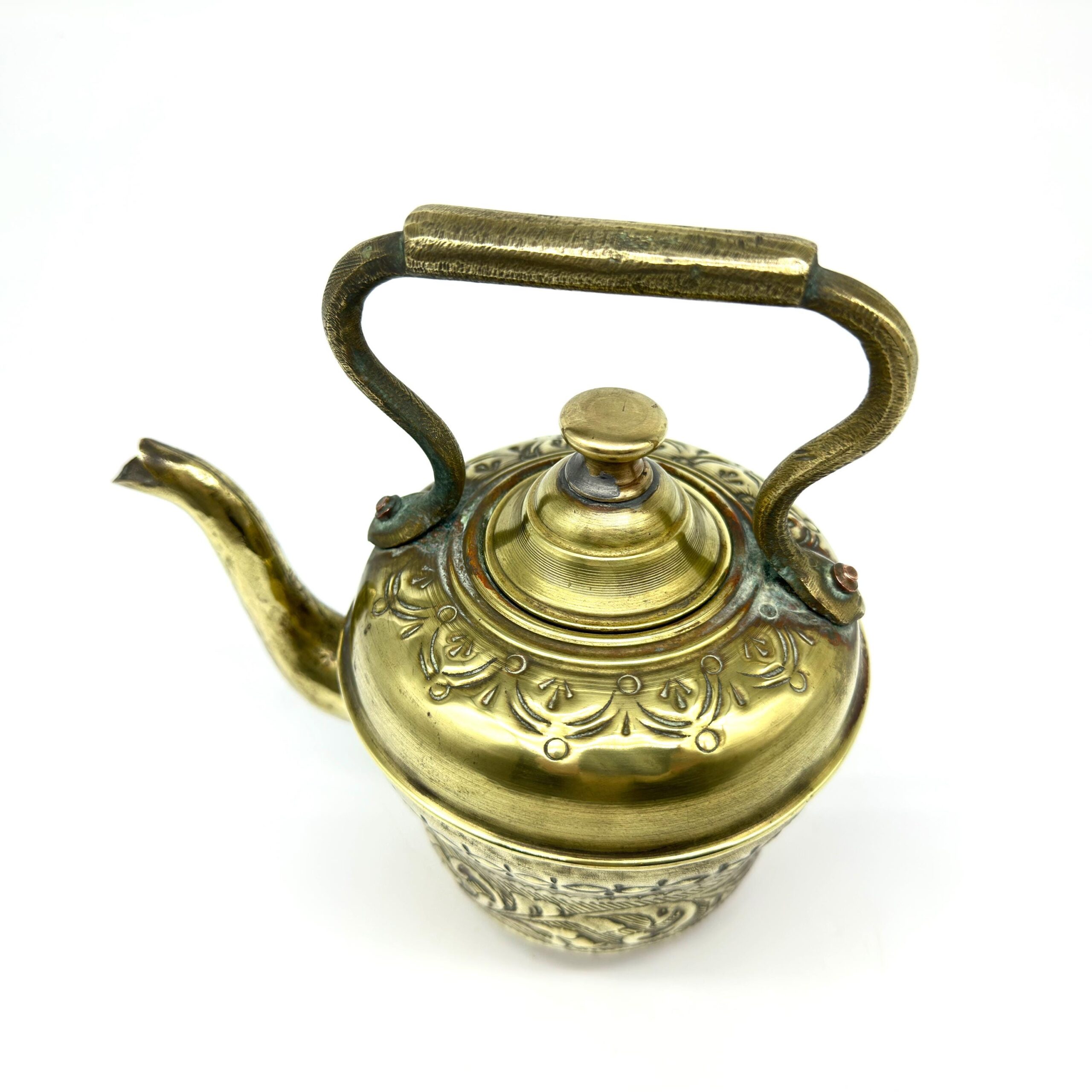 Ewer detail from above showing domed lid, finial top, spout, handle curve, and overall engraved surface in golden brass