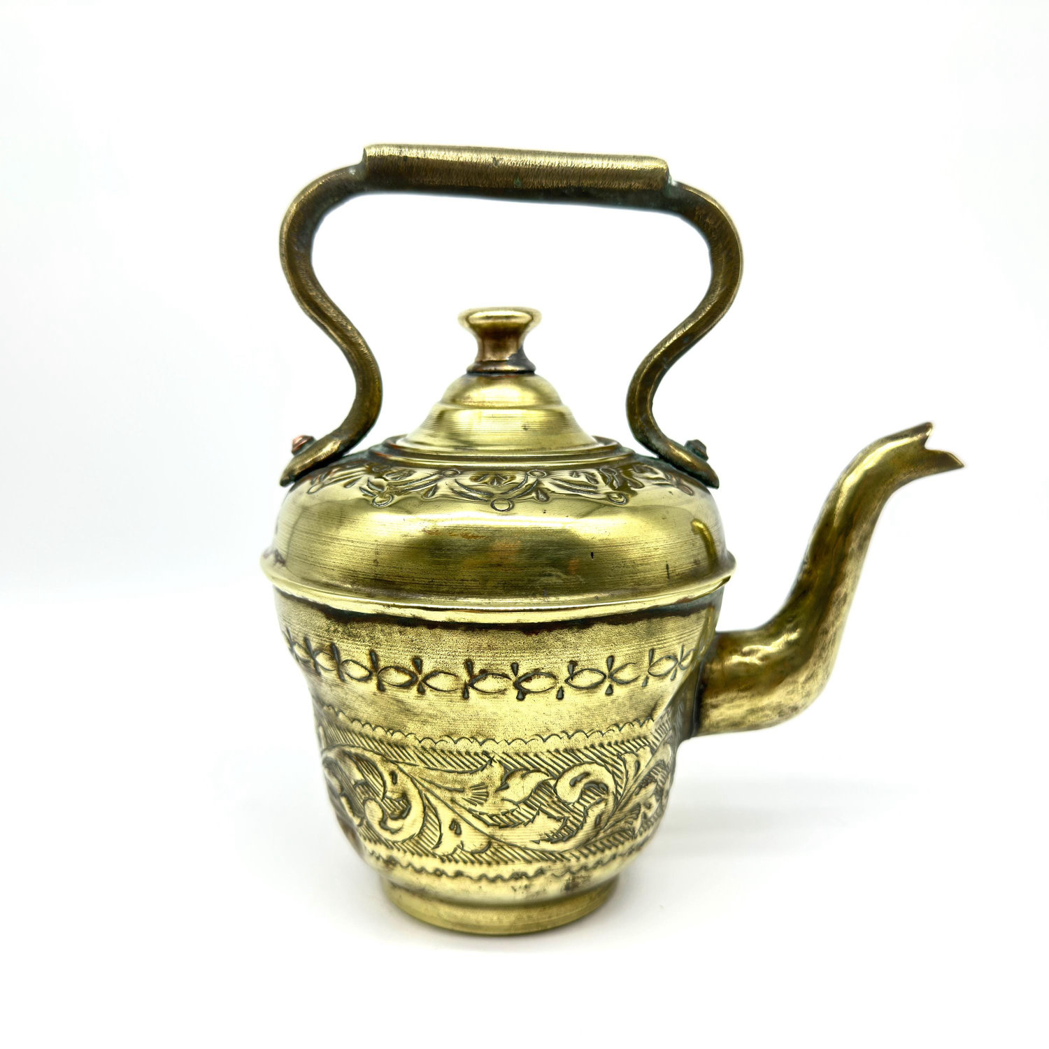 Ewer displayed solo showing curved spout, domed lid with finial, arched handle, and full engraved decoration in aged brass